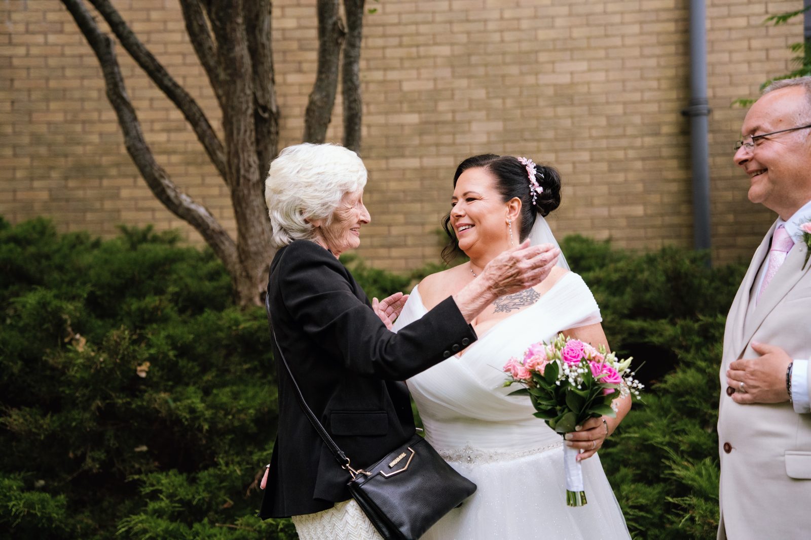 Emotional embrace between the bride and a family member
