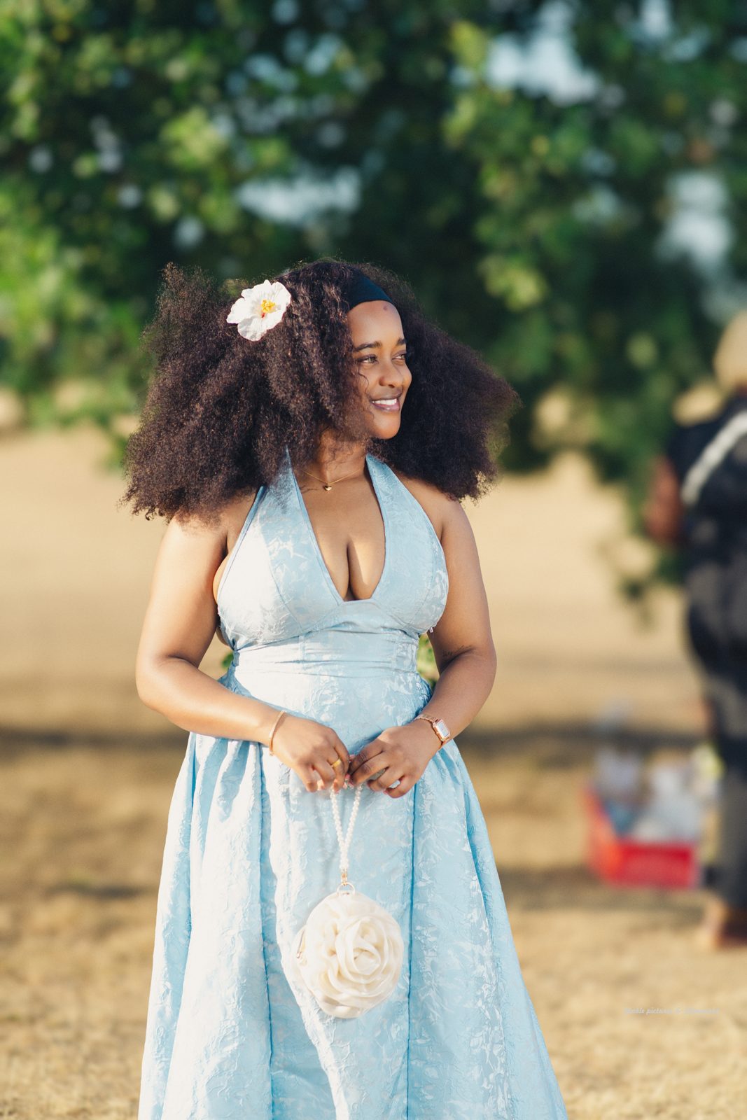 Elegant guest in a blue gown at an outdoor celebration