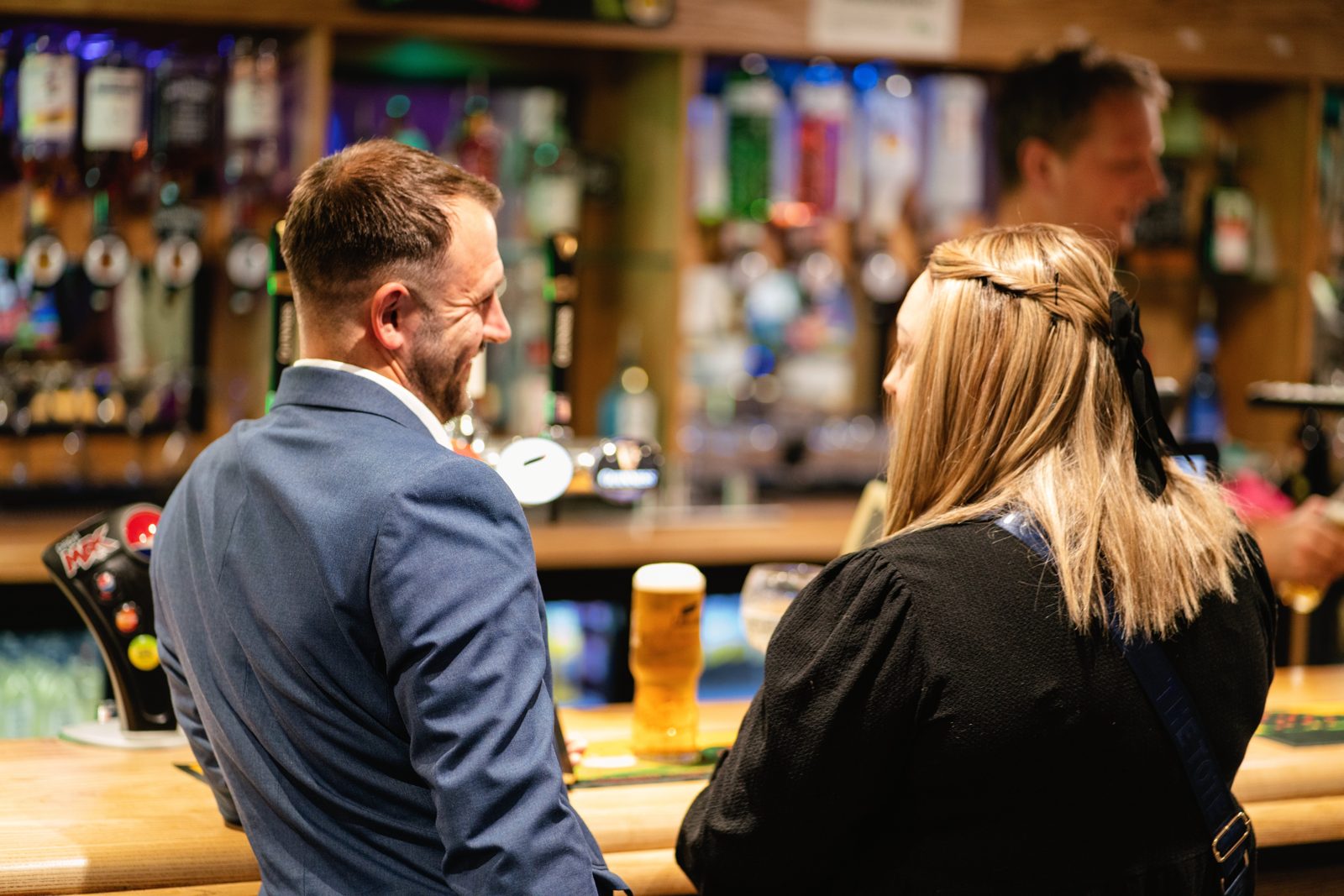Guests enjoying drinks together at the reception bar